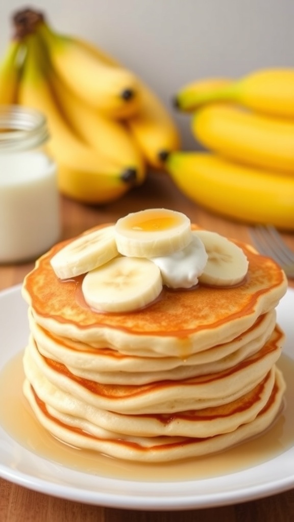 Fluffy banana yogurt pancakes topped with sliced bananas and yogurt on a white plate.